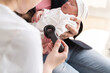 © Hernandez & Sorokina/Stocksy - Anonymous Doctor examining toddle skin