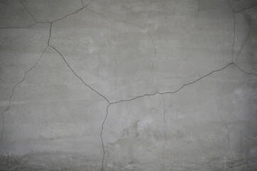 Cracked concrete wall texture background. close up of weathered and damaged mortar cement mortar facades.