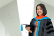 © mnirat - PhD graduate in black gown University bachelor degree.