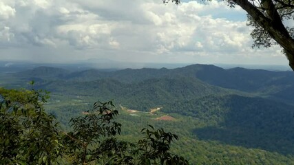 Wall Mural - Aerial shot of tropical rainforest mountains, Gunung Panti, Malaysia. Mountains, peaks, cliffs, rocks, ridges, landscape, green grass, sky, clouds, nature, uncultivated nature, view from mountain peak