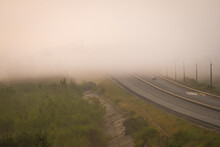 The Multi-lane Road Goes Into A Thick Fog Rising Over The Bridge We Pass Through The River