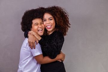 Wall Mural - black mother and son hugging on gray background