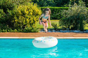 Wall Mural - cute little girl playing in the pool