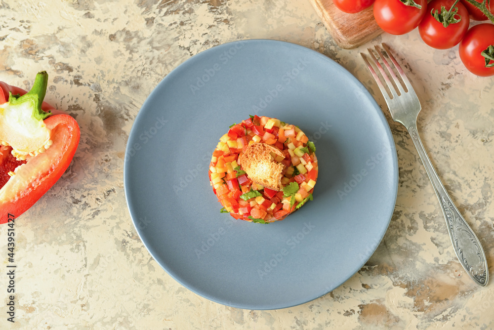 Plate with tasty tartare salad on color background
