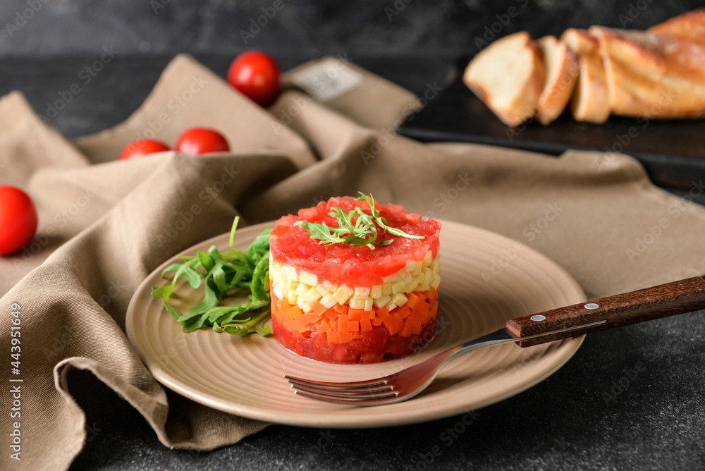 Plate with tasty tartare salad on dark background