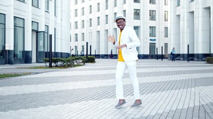 Wall Mural - Professional African American dancer in suit and hat dances