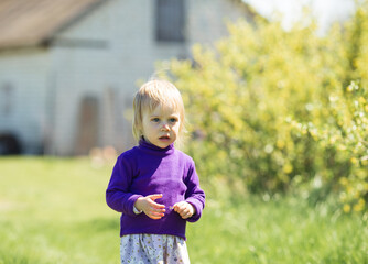 close-up portrait of a blonde girl in a purple jacket