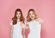 © SHOTPRIME STUDIO - two sisters white t-shirts hug friendship emotions pink background