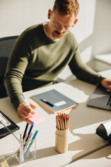 Wall Mural - Businessman making notes working at desk