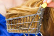 Girl with her long hair in shopping cart