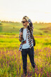 © Shopping King Louie - Young male tourist, in sunglasses, with a camera, in nature, spending time in a hike, on the field