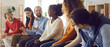 © Studio Romantic - Diverse team of people sitting in row and talking. Banner with happy young and mature black and white male and female community members sharing opinion and making suggestions in group meeting