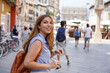 © zigres - Dynamic attractive traveler girl visits Italy with friends. Beautiful young tourist woman doing a quick tour of Europe in company.