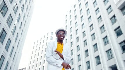 Wall Mural - African American performer dances on square among buildings