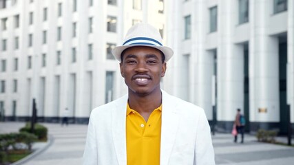 Wall Mural - Smiling African American businessman in white fedora hat