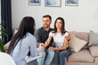 © standret - Couple is sitting on the sofa and working with female psychologist