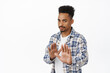 © Cookie Studio - No thank you, he pass. Reluctant serious african american guy stretch out hands in stop gesture, rejecting offer, refuse and decline, ask to stay away, dont come closer, white background
