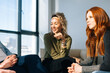 © dikushin - Close-up face young women listening intently to colleagues during brainstorming of start-up projects in modern office room near window in sunny day.