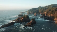 Sunset Light Over Ocean Waves Between Rocky Coast, Aerial Mountains Pine Forest
