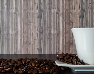 A cup of hot coffee and coffee beans. Hot coffee on a black background.