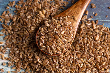 Pile of Bulgur Wheat on a Rustic Blue Table