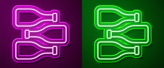 Glowing neon line Bottles of wine icon isolated on purple and green background. Vector