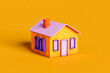 © Giada Canu/Stocksy - a violet and orange house on orange background