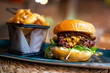 © Luis Velasco/Stocksy - Delicious Burger With Cheese And French Fries.