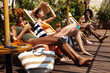 © BONNINSTUDIO/Stocksy - Multiracial women sunbathing on terrace