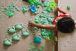 © Chalit Saphaphak/Stocksy - Asian boy playing kinetic sand