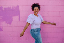Beautiful Curvy Woman In Front Of Pink Wall