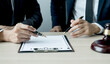 © Lucky7Trader - Lawyer hand holding pen and providing legal consult business dispute to the man