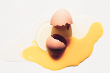 A Broken Egg In A White Background