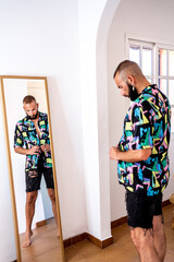 Modern man getting ready looking at mirror