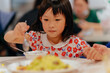 © Pansfun Images/Stocksy - little girl eating at the dinner table