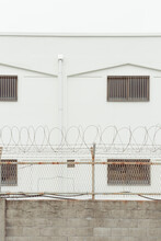 Close-up Of A Building Wall Surrounded By Barbed Wire