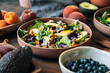 © Nataša Mandić/Stocksy - Peach salad with avocado, blueberries, walnuts and pansy flowers