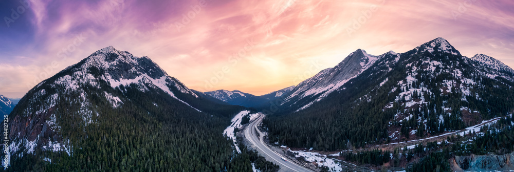 Aerial Panoramic View of a scenic Highway passing in the Canadian Mountain Landscape. Dramatic Sunset Sky Art Render. Taken near Hope and Merritt, British Columbia, Canada. - obrazy, fototapety, plakaty 