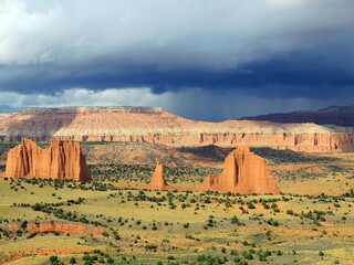Wall Mural - dramatic view of eroded red rock formations from the upper cathedral valley overlook on a stormy day, cathedral valley drive, capitol reef, utah