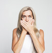 © Raisa Kanareva - Portrait of beautiful nice shocked gray-haired old woman covering her mouth with palms.