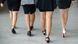 © Bangkok Click Studio - Back view of four attractive female legs of office colleagues in formal business suits and skirts walking in office. Concept for modern office working