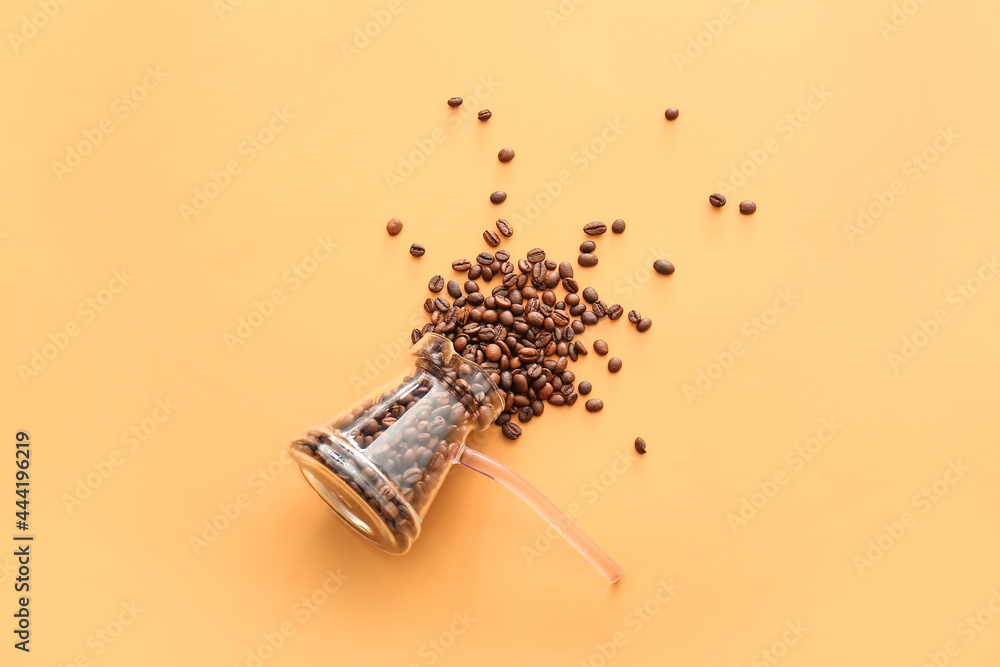 Cezve with coffee beans on color background