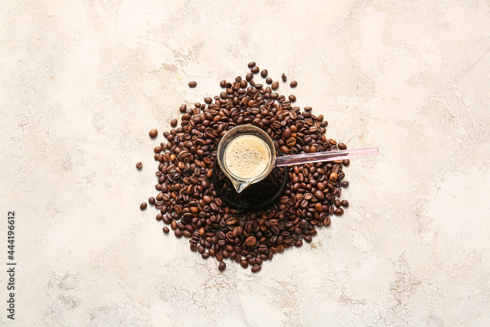 Turkish coffee in cezve and beans on grunge background