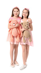 Poster - Cute twin girls with toys on white background