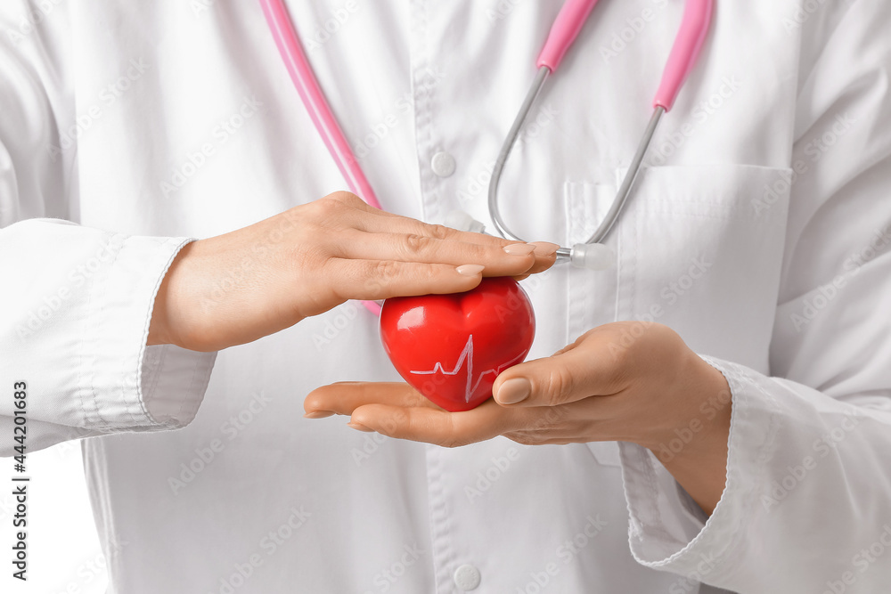 Female cardiologist with red heart, closeup