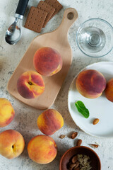 Wall Mural - Ripe peaches for breakfast on a light concrete table, morning summer time