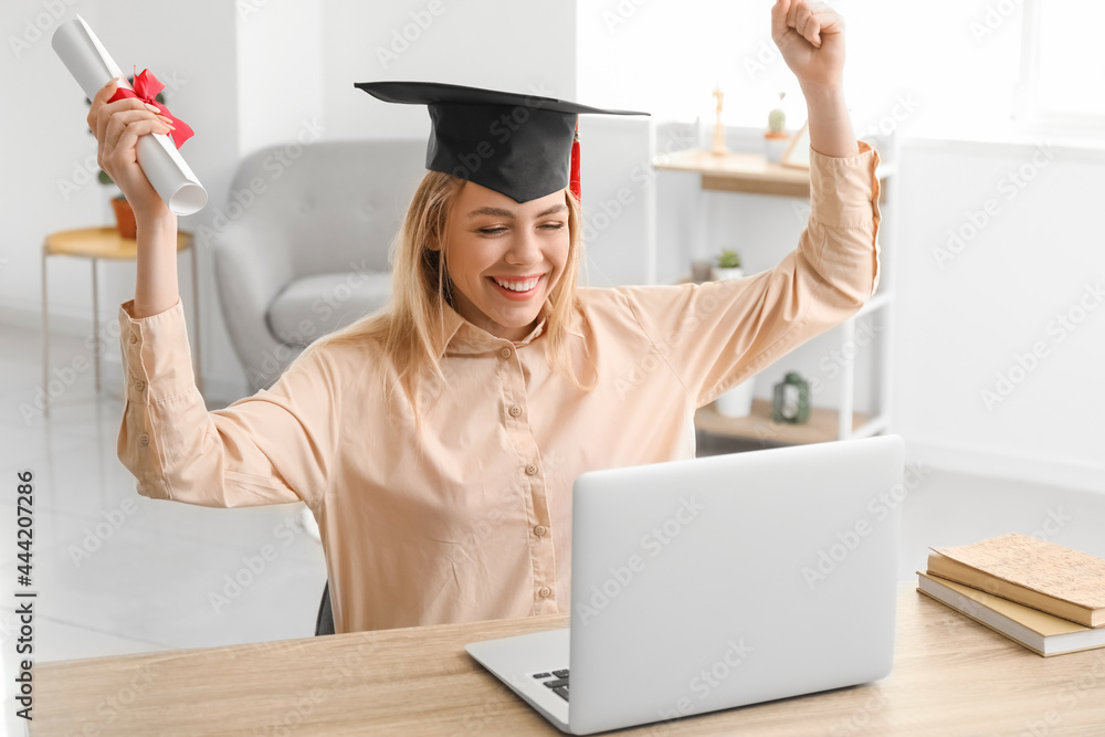 Happy female student on her graduation day at home. Concept of online education
