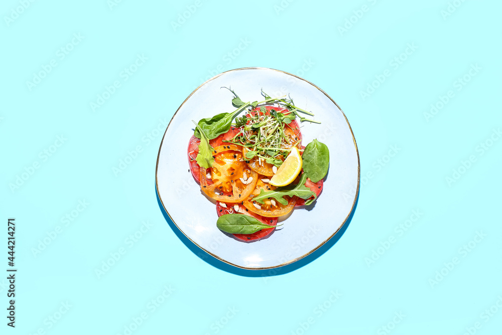 Plate with tasty tomato carpaccio on color background
