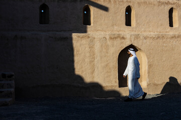 Wall Mural - Middle Eastern Arab Emirati man exploring Fujairah Fort in the United Arab Emirates