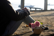 Person Sitting Alone With Roses On A Cup, A Daydreaming At Sunrise.